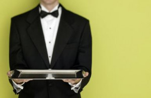 butler holding a silver tray. -