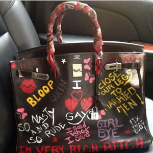 ... scrawled sayings such as 'I'm very rich bitch' on the expensive purse