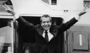 Richard Nixon waves goodbye with a victorious salute as he boards a ...