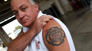 Fire chief Billy Rhoads displays his tattoo of brotherhood. 