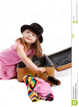 Girl packing old-styled shabby suitcase, isolated.