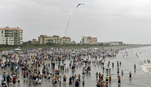 ... on sand at Cocoa Beach, Florida to watch the shuttle pierce the clouds