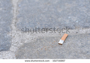 Cigarette Butt Discarded Outdoors On The Floor Of A Granite