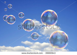 Colorful Soap Bubbles Against Blue Sky Background - stock photo