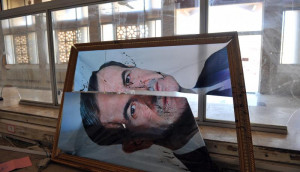 broken picture of former Syrian president Hafez al Assad at the Bab