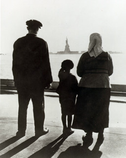 ... immigrant family on Ellis Island, gazing across the bay at the Statue