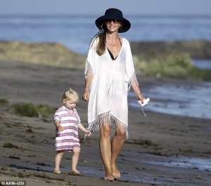Rebecca Gayheart stays cool in low-cut frock and floppy hat as she ...
