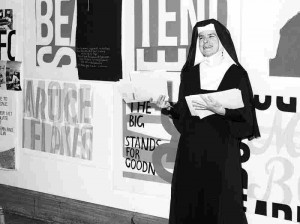 Sister Corita Kent stands in front of her work, including for eleanor ...