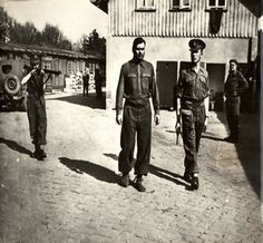 ... Belsen, Germany. Camp kommandment Josef Kramer being led under guard