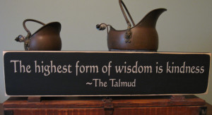 wood sign from the Talmud reading, The highest form of wisdom ...