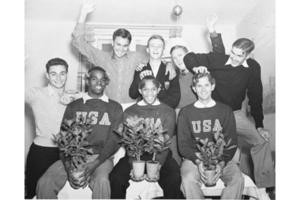 ... gold medal on the American team, including Jesse Owens (seated left