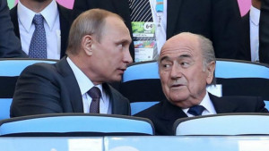 ... president Vladimir Putin sit together at the 2014 World Cup final