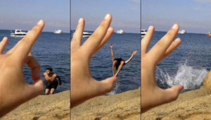 ... with a flick: This beachgoer is thrust into the sea by a giant hand
