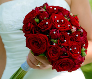 An all red bouquet or red roses, accented with pearls.