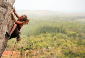 Woman rock climbing in Vinales, Cuba.
