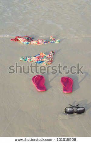 Skinny dipping concept shot showing a bikini on the beach - stock ...