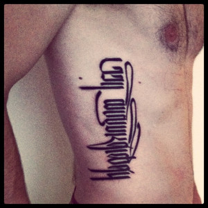 ... any pictures of tattoos in which the font is vertical. down the body