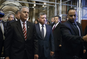 Uncompromising language; King Abdullah of Jordan, (center), is hurried ...