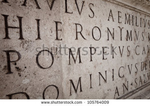 Latin words engraved on a column in Roman Capitol - stock photo