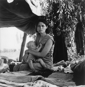 Evacuee stands by her baggage