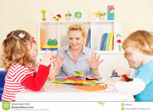 Preschool: Young smiling teacher discussing with group of children ...