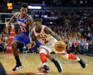 ... stop the Bulls' Nate Robinson. Credit Jim Prisching/Associated Press