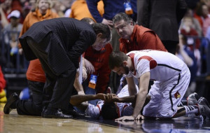 Louisville Cardinals guard Kevin Ware (bottom) is checked on by guard ...