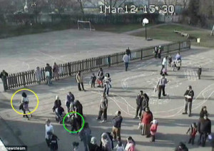 Daniel (circled in green) is seen leaving Little Heath Primary School ...