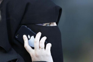 women, wearing a niqab despite a nationwide ban on the Islamic face ...