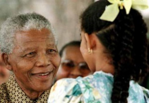 PRESIDENT MANDELA SPEAKS TO A YOUNG GIRL.