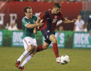 midfielder Robbie Rogers (16) is pulled down by Mexico defender ...