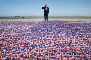 salutes as he looks at British Legion Union flags carrying thank you ...