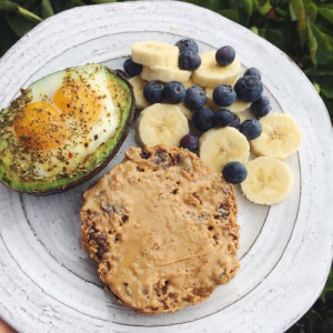Breakfast! an egg cracked in half an avocado and baked in the oven, a ...