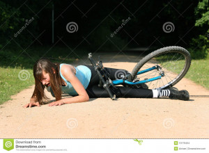 Female bike rider takes a tumble and crying in pain on the ground.