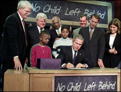 President George W. Bush, seated, signs the No Child Left Behind ...