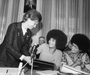 leader of the Soviet Women's Committee (left) hands a memento to ...