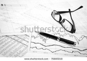 ... the charts and quotes prints, the eyeglasses and a pen - stock photo
