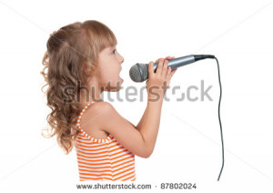 little girl singing with a microphone isolated on white background ...