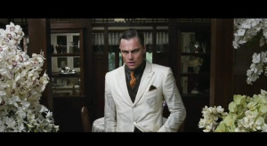 Gatsby, pale as death, with his hands plunged like weights in his coat ...