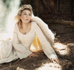 Stock photo : Beautiful blond angel woman sitting