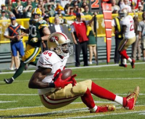 San Francisco’s Randy Moss catches a touchdown pass during the first ...