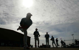 Cole Hamels is silhouetted against the Florida sky with other Phillies ...