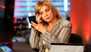 Al-Arabiya news channel presenter Mortada puts on make up in studio in ...