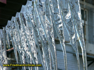 Icicleshang along a roof edge on a cold winter's day.