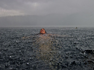 Photo: A woman swimming in a lake in Chile during a rainstorm