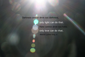 sun rays and beams out of focus on a black back round with a quote by ...