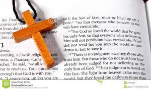 Wooden cross next to the Bible verse of John chaper three verse ...
