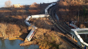 Cars from a Metro-North passenger train are scattered after the train ...