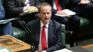 Leader Bill Shorten listens as Prime Minister Tony Abbott quotes ...