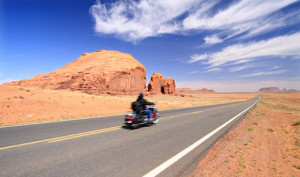 motorcycle rider driving down the highway.